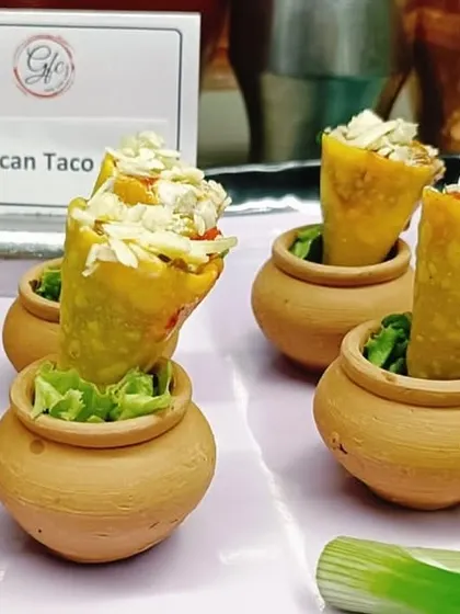 A taco with a twist! We serve our zesty Mexican taco filling in a crispy cone, presented in charming terracotta pots for a rustic yet playful touch.