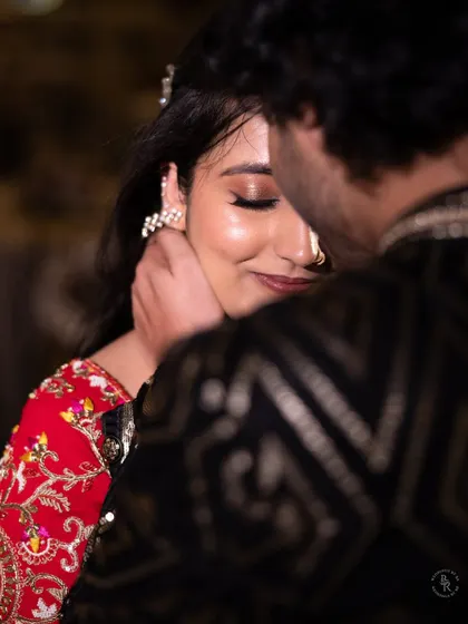 An intimate close-up of a couple, their faces close together, capturing a tender moment of affection during their celebration.