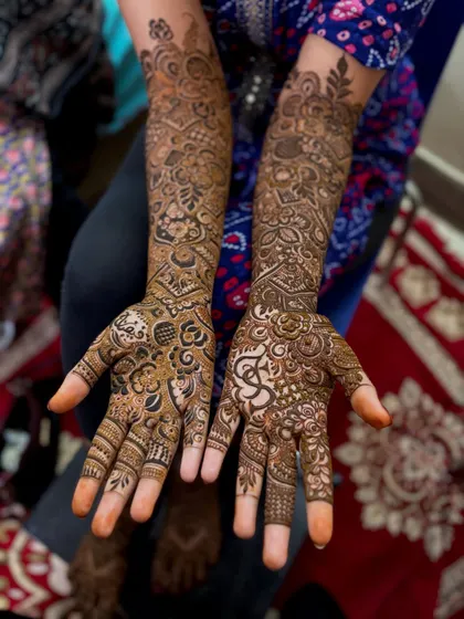 A complete view of a heavy bridal mehndi design. The patterns are dense and varied, with each section telling its own story while contributing to the overall magnificent look.