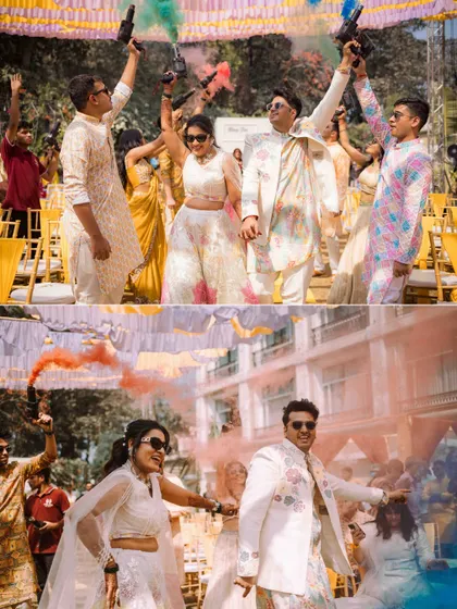 A grand entrance with a bang! The couple enters their Haldi celebration with colorful smoke bombs, creating a vibrant and exciting photographic moment.
