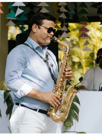 Setting a smooth and soulful mood with a live saxophonist at a poolside party. Live music is a fantastic way to elevate the ambiance of any daytime event.