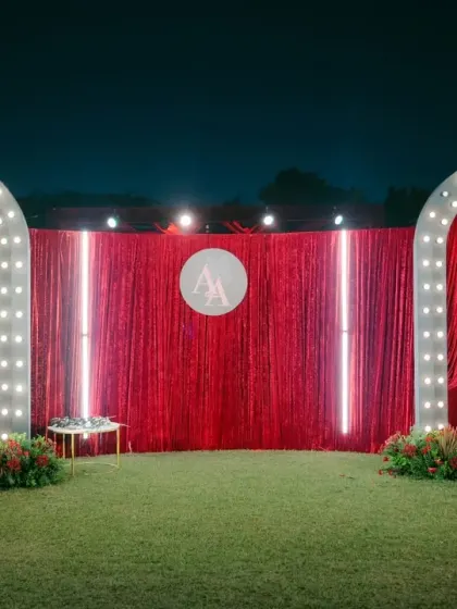 Inspired by the glamour of Broadway, we designed this grand Sangeet entrance with red velvet drapes and sparkling marquee lights, setting a theatrical and exciting tone for the evening's festivities.