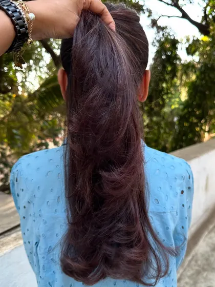 The ponytail view of the 'Mahogany + Plum' hair.