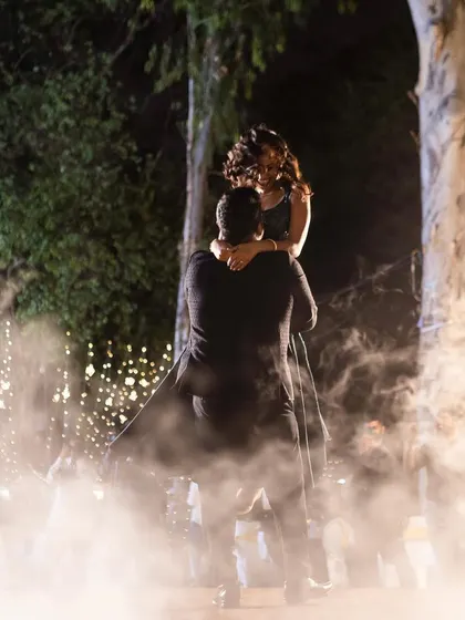 A stunning lift amidst the smoke, this shot captures the pure magic and romance of a perfectly choreographed first dance.