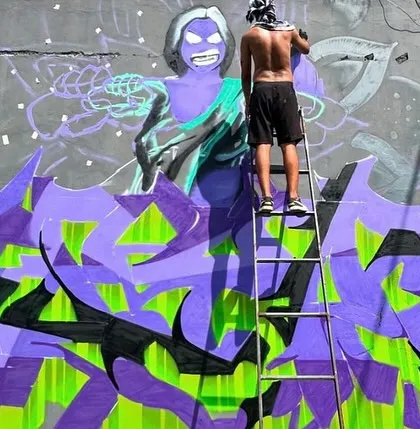 Another angle of me working on the 'Attitude Adjustment' piece. You can see how the character and the graffiti lettering start to come together on the wall.