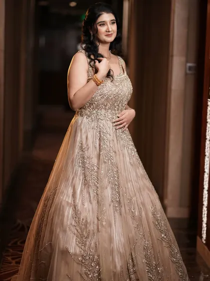 A full-length portrait of the bride-to-be in her gorgeous gown. The makeup and hair complete her elegant look.