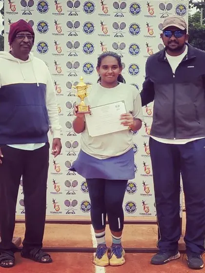The Girls Singles Winner of the AITA TS7 U-14 tournament, Thanu Vishwas, proudly holds her trophy and certificate.