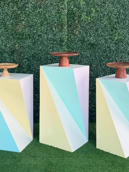 Our twisted cube cake tables feature a modern geometric design in pastel colors. They can be grouped together to create a multi-level dessert display.