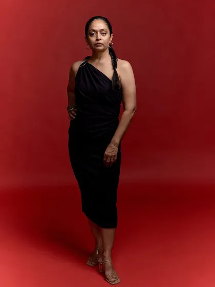 A full-length view of the milestone birthday portrait. This shot captures the grace and poise of the subject, telling a story of fifty years of growth and self-acceptance.