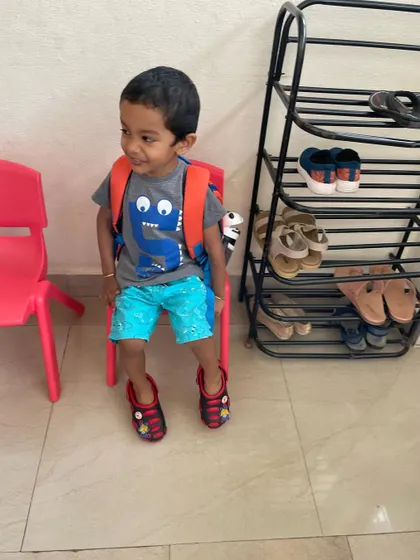 The day ends as it began, with independence. This young student puts on his own shoes, a simple act that represents the confidence and self-reliance we nurture through practical life skills every day.