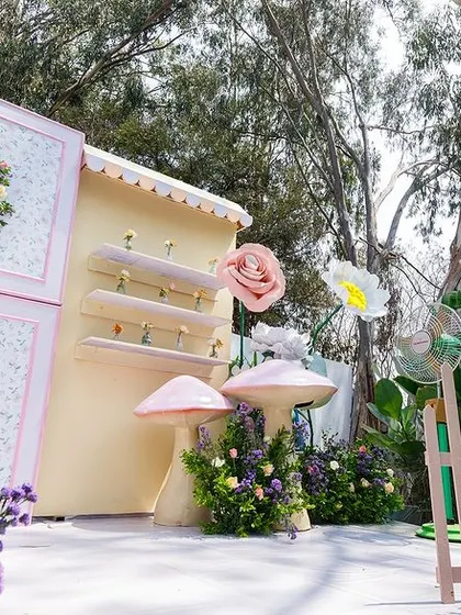 A wide view of the flower garden stage, showing how the different levels, props, and floral arrangements create a dynamic and visually stunning backdrop for the celebration.