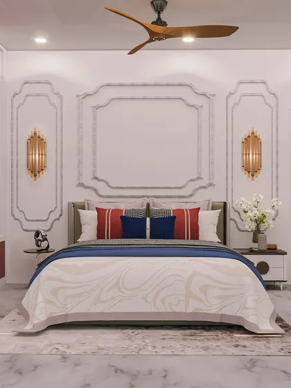 The bed is framed by elegant wall moldings and sophisticated sconce lights, creating a timeless and luxurious feel.