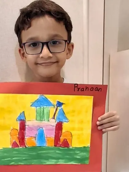 This student proudly presents his castle masterpiece. The focus and effort put into the drawing process result in a final piece he is excited to show off.