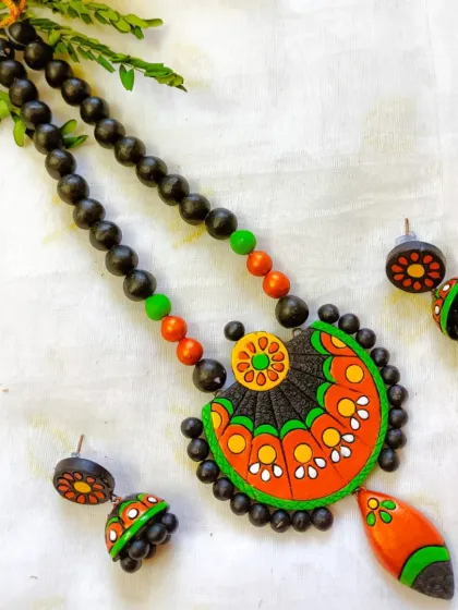 A green and orange version of the fan-design necklace.