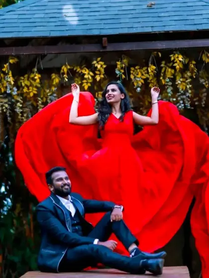 The trails of our red flying dress are arranged to form a heart shape around the couple, a creative and romantic idea for a pre-wedding shoot.