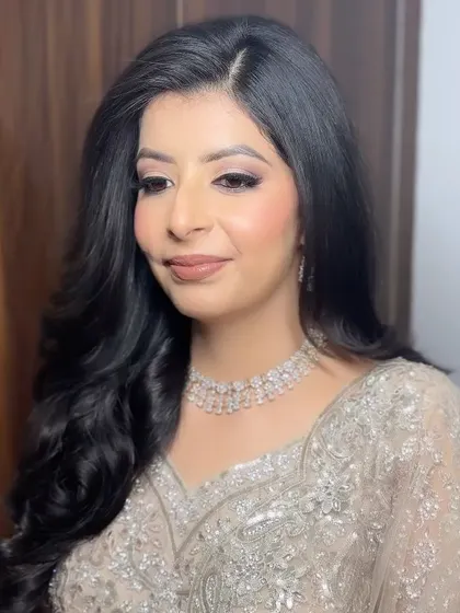 A portrait of Kanika, showing her soft waves and the elegant, understated makeup for her engagement.