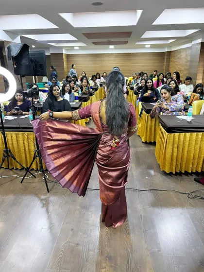 The beautiful result of a perfectly pleated and draped saree, showcased to the class.