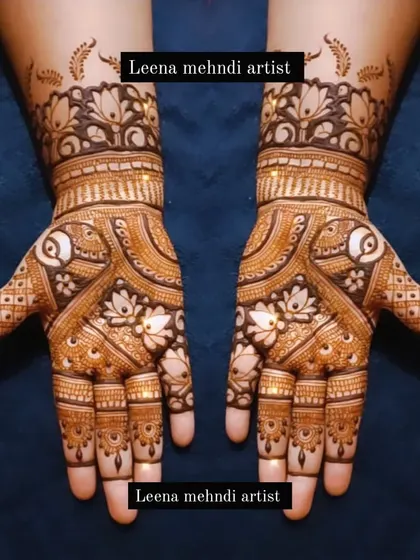 This design combines the grace of paisleys with the beauty of lotus flowers. The use of negative space around the main motifs makes them stand out, creating a sophisticated bridal look.