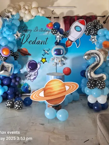 A clear, bright photo of the space-themed birthday decoration for Vedant.