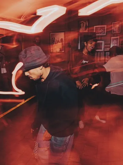 A motion-blur shot capturing the dynamic movement and energy of the dance floor.