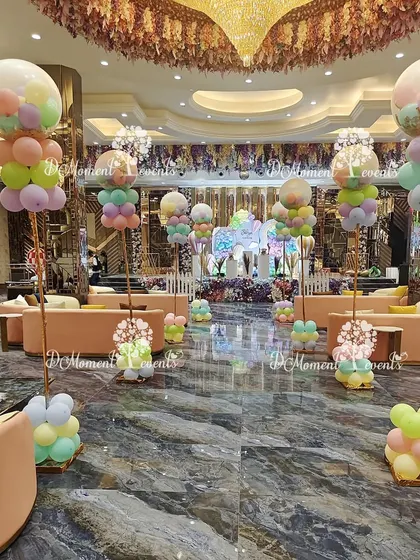 The hot air balloon theme extends to the venue's decor with these elegant balloon arrangements on tall stands, creating a sense of height and wonder.