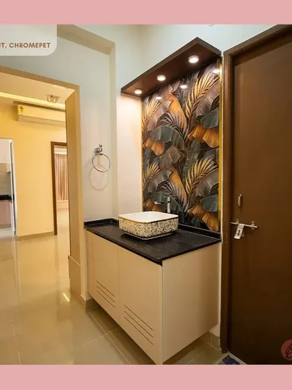 A stylish vanity unit from the Chromepet project, with a designer sink, a tropical-themed tile backsplash, and overhead spotlights creating a chic corner.