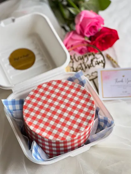 A trendy and unique bento cake featuring a red and white gingham print made entirely from buttercream. This design is perfect for a stylish, picnic-themed celebration.