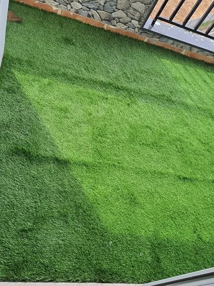 A completed artificial grass installation in a small utility balcony. Even the smallest spaces can be made greener and more pleasant.