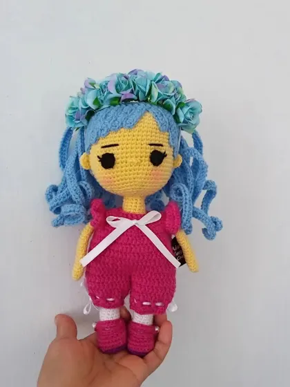An original anime-style doll with bright blue hair and a pink outfit. I enjoy creating these colorful characters.