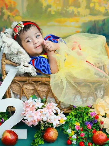 A little Snow White celebrating her half-birthday. This fairytale theme, complete with a forest backdrop and woodland creatures, is a magical way to mark the six-month milestone.