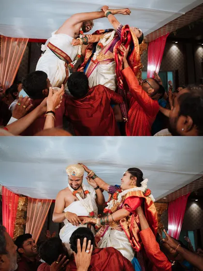 The fun and games of a South Indian wedding, as the bride and groom are lifted up by their families for the garland exchange. It's a moment of playful competition and joyous celebration.