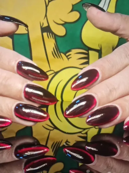 A full view of the striking red and black cat-eye manicure, perfect for a bold statement.