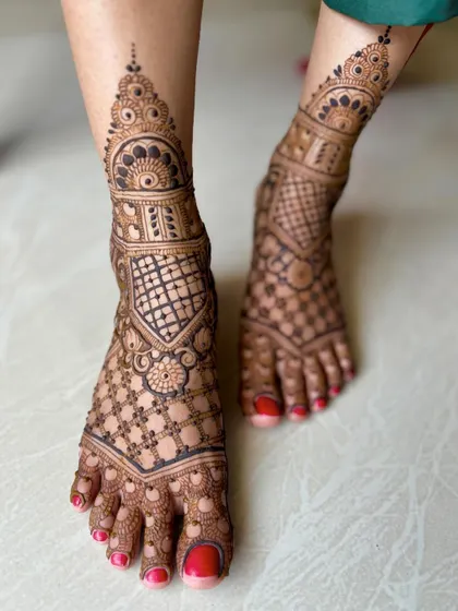 A full-coverage feet design with dense geometric and floral patterns, perfect for a bride.