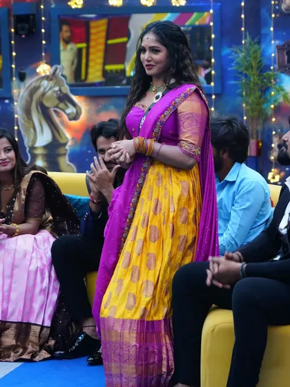 Actress Bhavya Gowda in a stunning yellow and magenta langa voni inside the Bigg Boss Kannada house.