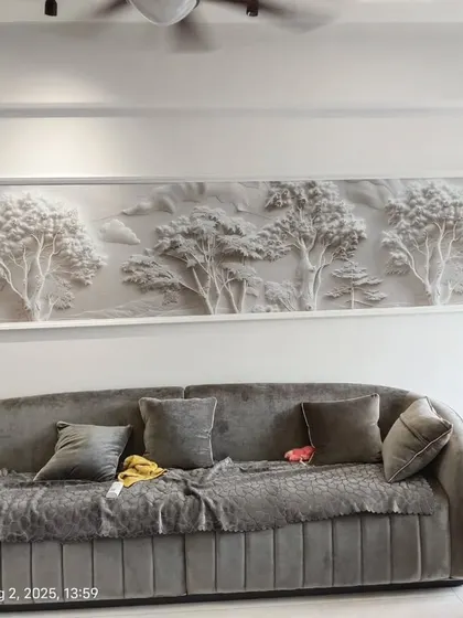 For this living room in Mulund, I installed a white 3D landscape panel. This type of textured wallpaper creates an artistic, sculptural effect that changes with the light, adding a sophisticated touch above the sofa.
