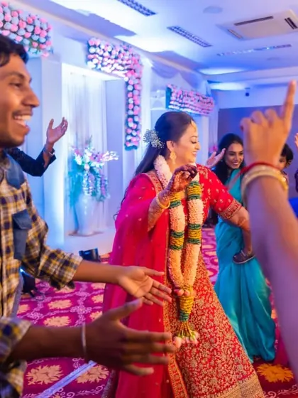 The bride is all smiles as she dances with her friends. The open floor is a chance for her to celebrate and have fun with her closest companions.