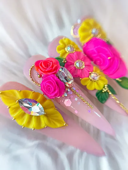 A different angle of the vibrant 3D floral nails, showing the layering of petals and the placement of crystals to create a truly luxurious design.
