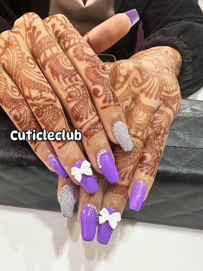 Perfect for an engagement or sangeet, this vibrant purple nail set is paired with silver glitter accent nails. The look is finished with cute 3D white bows and a line of rhinestones for extra flair.