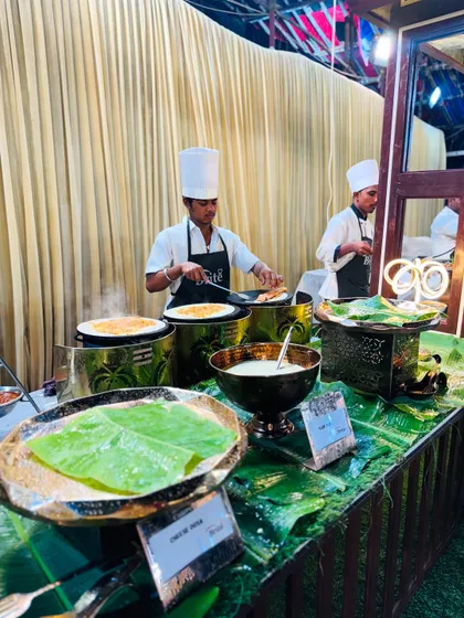 The bustling South Indian station, where multiple chefs prepare dosas on hot plates for waiting guests.