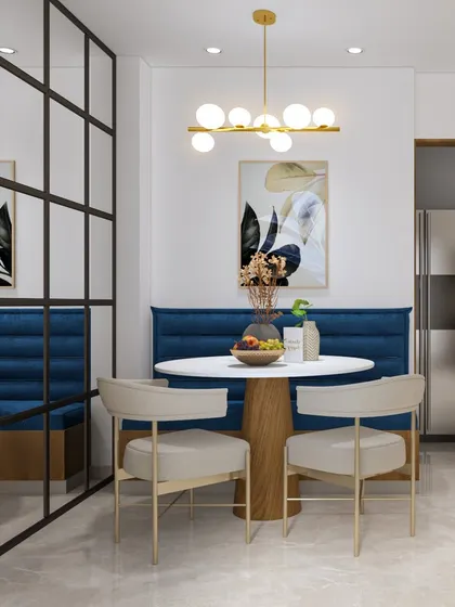 A cozy dining nook featuring booth-style seating in a rich blue fabric. The glass partition maintains an open feel while defining the space, making it perfect for intimate family meals.