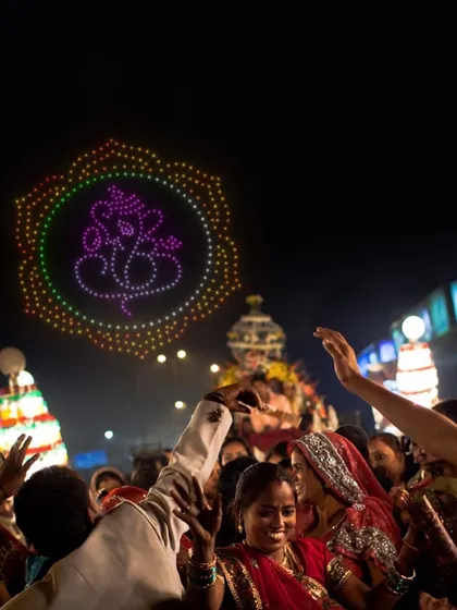 A celebration of Indian culture with a Ganesha drone formation over a festive crowd. As a leading drone show provider in India, I specialize in creating shows that resonate with local traditions.