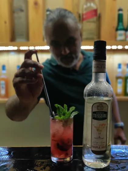 The final stir of a masterpiece. This cocktail, featuring Triple Sec, shows how a simple garnish and the right technique can elevate a drink.