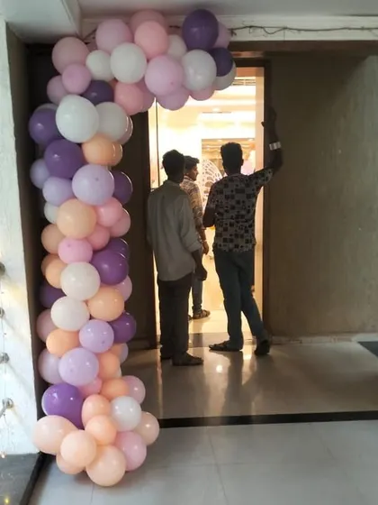 This is another look at our butterfly-themed decor, showing a partial arch that beautifully frames a doorway. The blend of purple, peach, and white balloons offers a sophisticated and enchanting welcome for your guests.