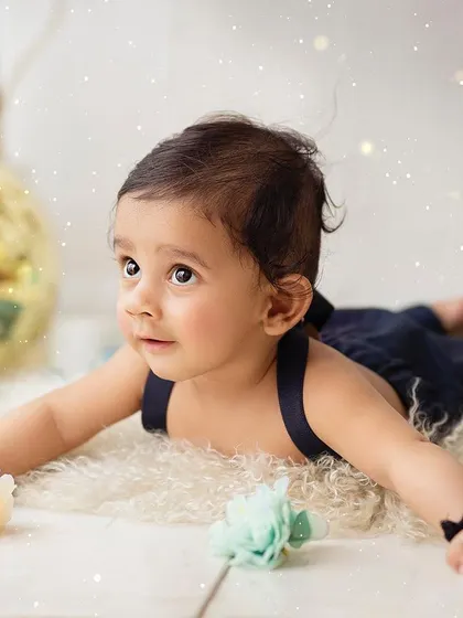 Tummy time! This pose is great for sitter sessions, showing off your baby's strength and curious nature.