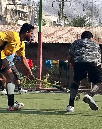 An attacker skillfully maneuvers the ball past a defender. Our drills are designed to improve dribbling techniques and the ability to maintain control under pressure.