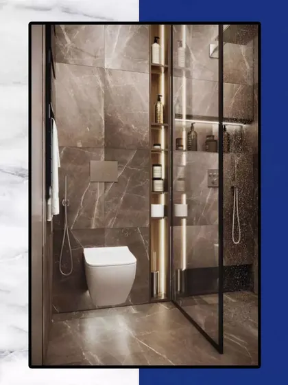 We create bathroom designs that take your comfort to the next level. This space features a glass-enclosed shower, built-in shelving, and high-end marble for a truly delightful experience.