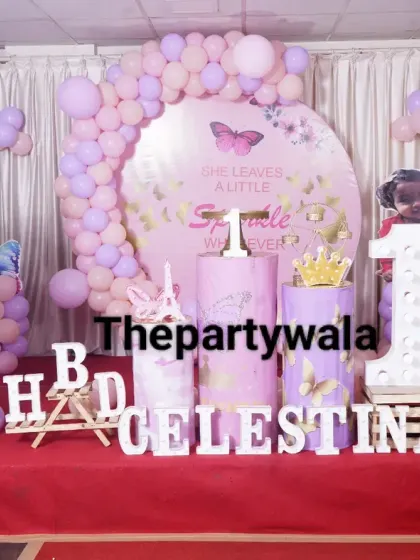 A fairy tale butterfly theme with a 'She leaves a little sparkle' backdrop, perfect for a magical first birthday.
