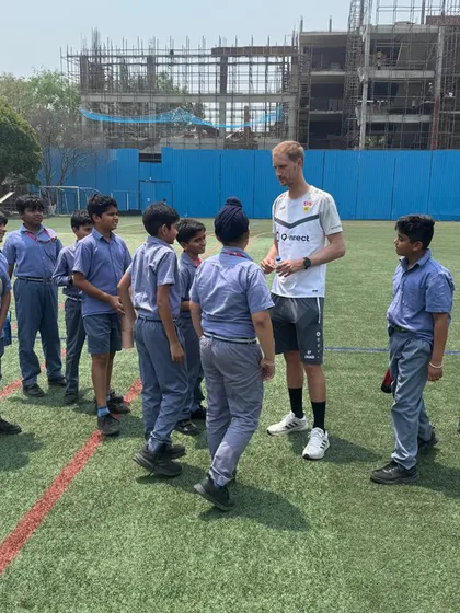 A VfB coach interacts with a group of school children during the camp. We aim to spread the passion for football to the wider community.