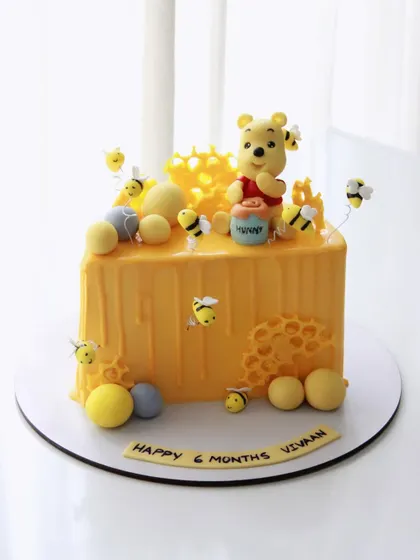 A full square view of the Winnie the Pooh cake, showing all the sweet details.