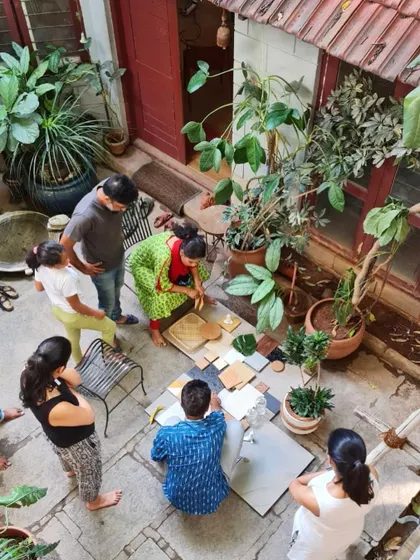 Our team and clients gather in the studio courtyard to create a material palette. This hands-on, collaborative session is a crucial part of our design process, ensuring the final home reflects the client's personal style.
